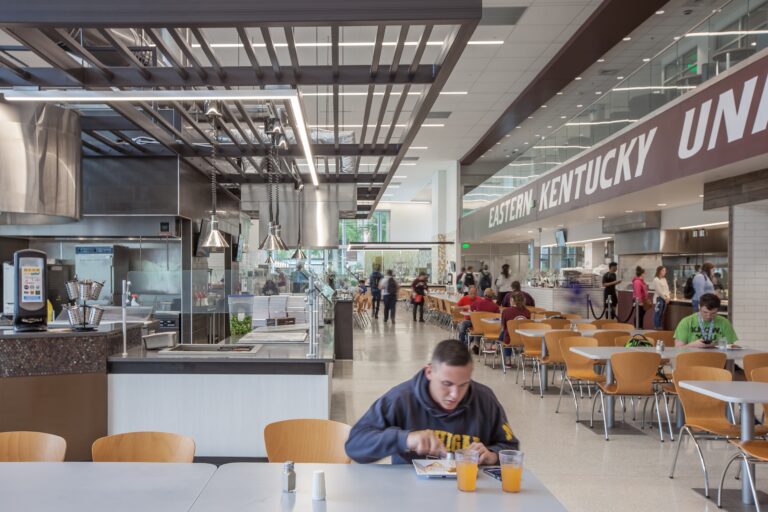 student eating lunch at a college campus dining facility
